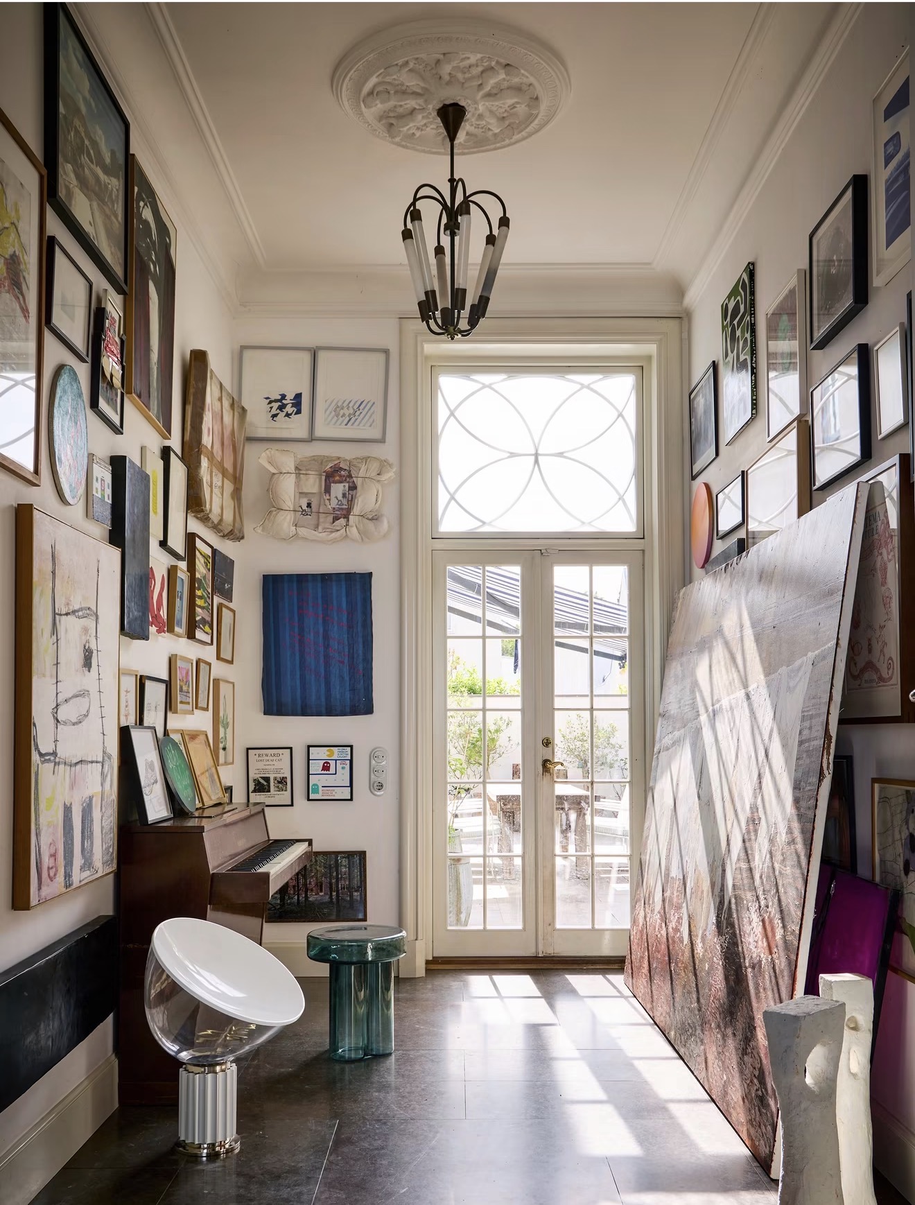 Private interior filled with framed works, paintings and sculptures